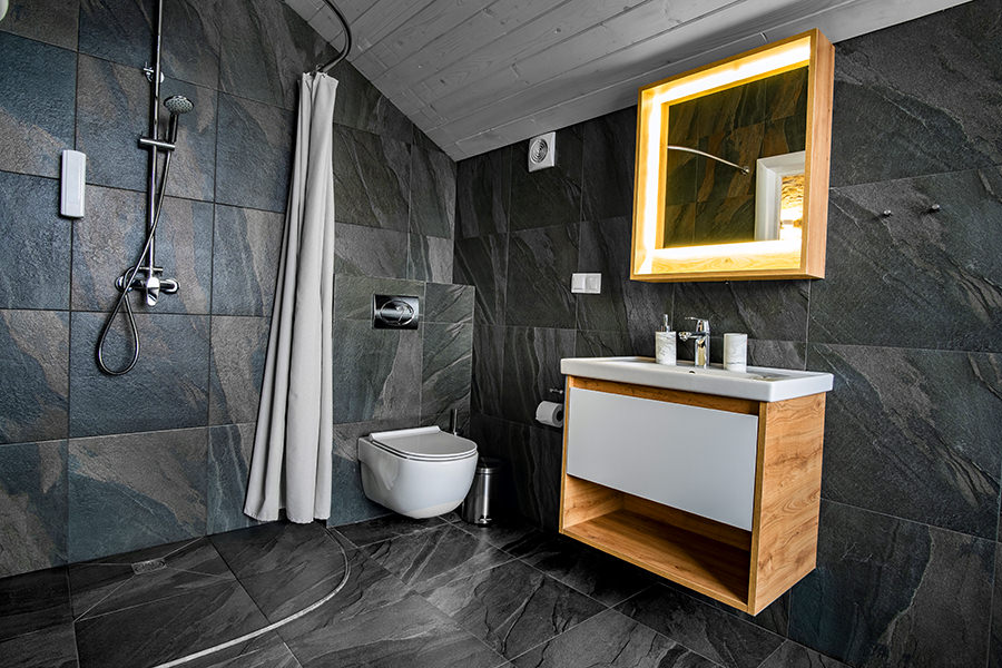 Grey Bathroom Floor Tiles with Black Bath and Curtains